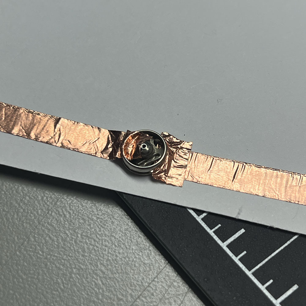 Making test of low voltage electricity using metal button close in detail #4.